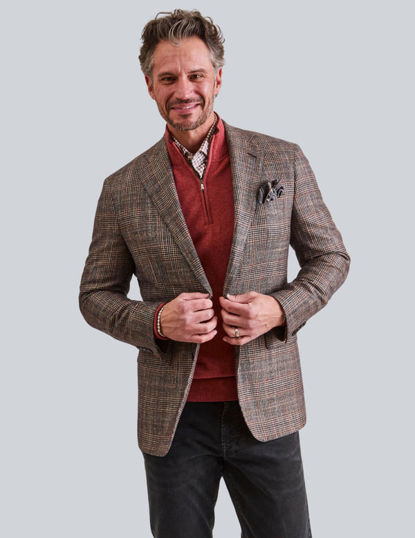 Man wearing chocolate brown plaid jacket with orange highlights from M PENNER in Houston, Texas
